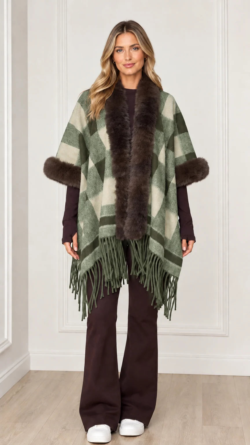 Woman wearing sage green plaid poncho wrap with faux fur collar and hem tassels