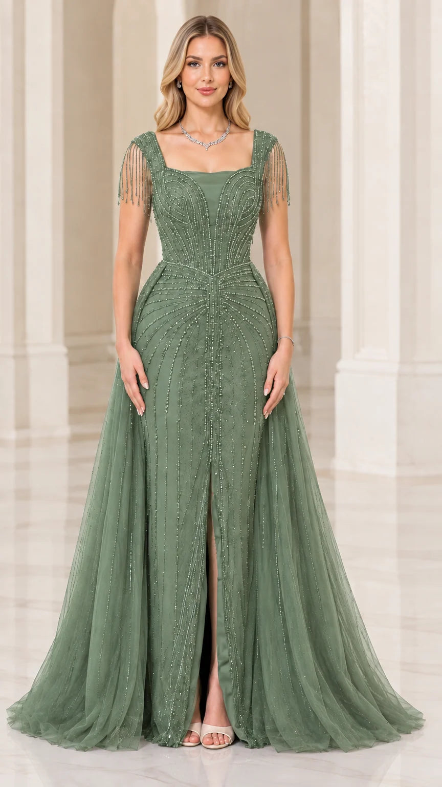 Full-length front view of sage green beaded evening gown with front slit and overskirt