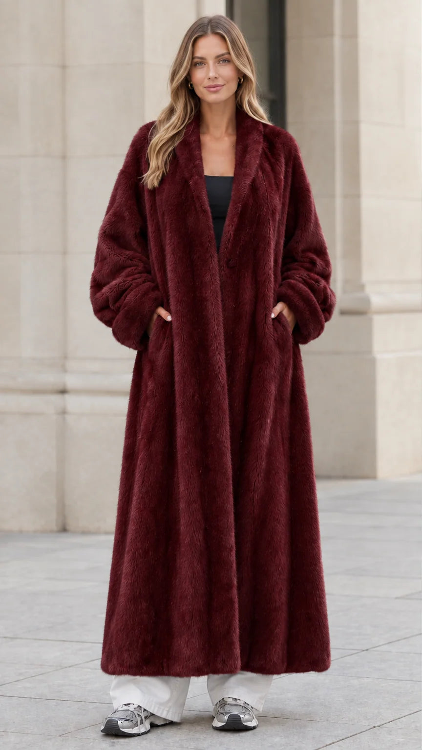 Front view of woman wearing deep burgundy red plush faux fur maxi coat