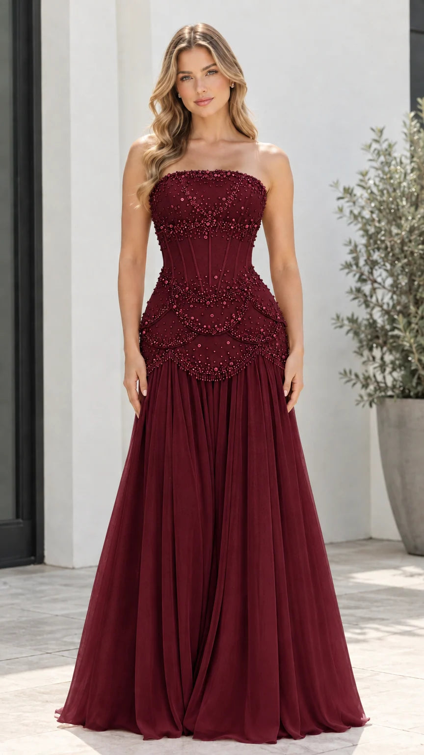 Model wearing Burgundy red strapless beaded corset formal maxi gown
