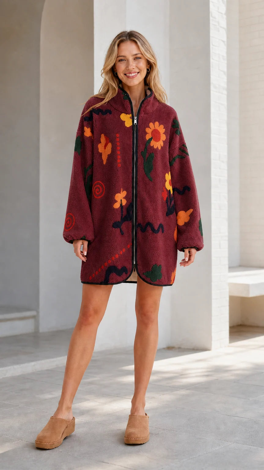 Front view of a burgundy women's floral printed fleece zip-up jacket