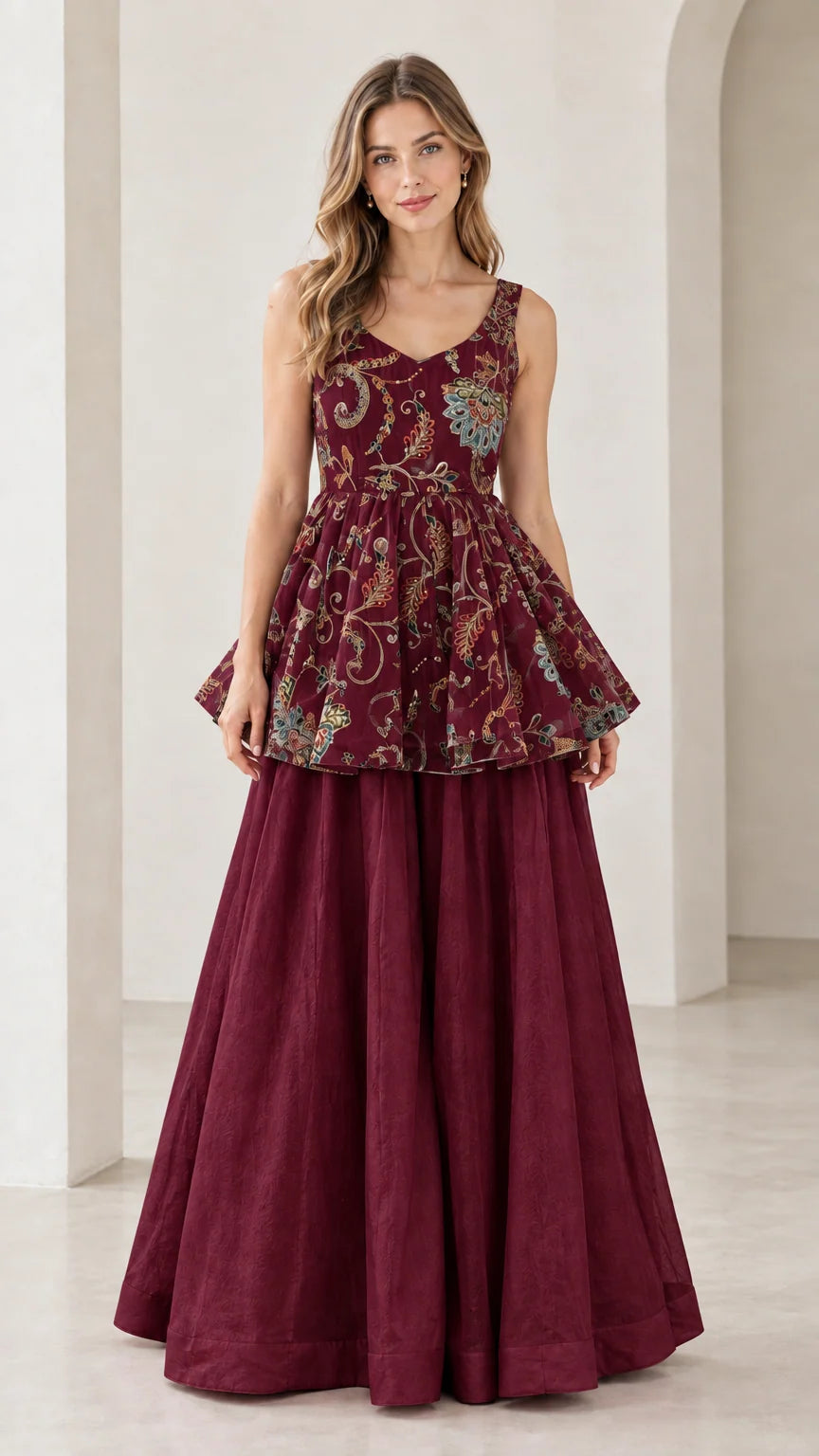 Front view of model wearing wine red floral embroidered peplum and palazzo set