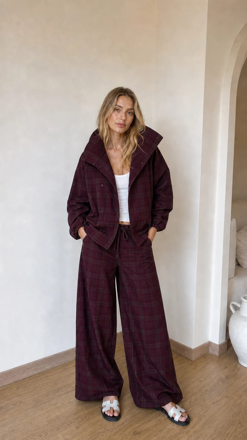 Model wearing burgundy wine plaid jacket and coordinated wide-leg trousers