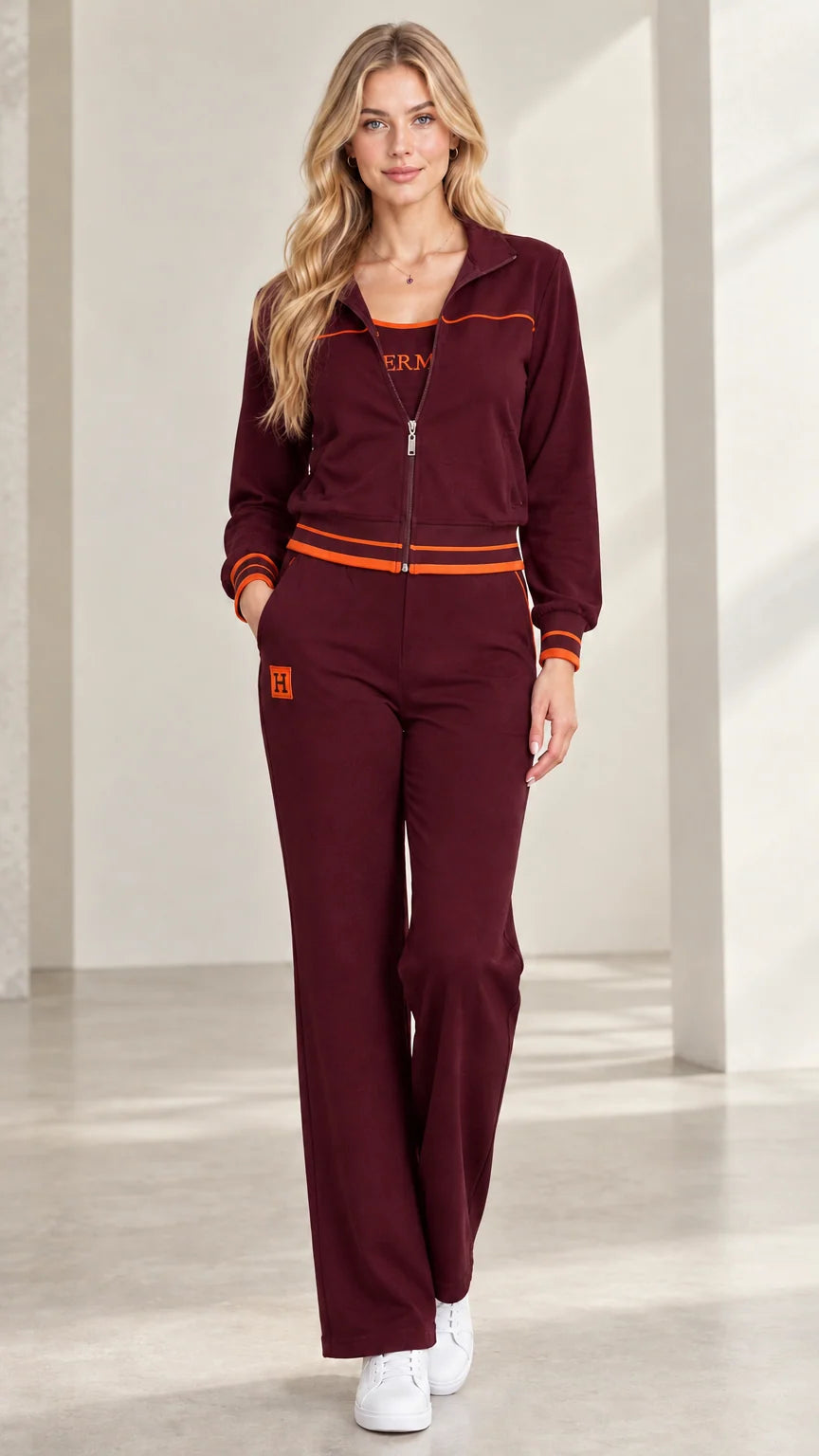 Woman wearing burgundy wine red two-piece zip-up tracksuit set