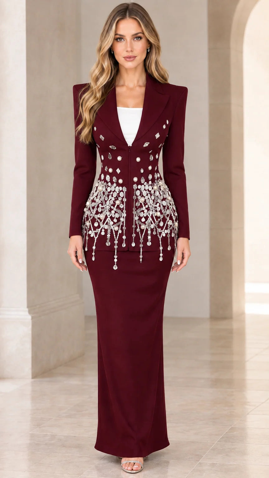 Model wearing rich burgundy embellished formal blazer and maxi skirt set