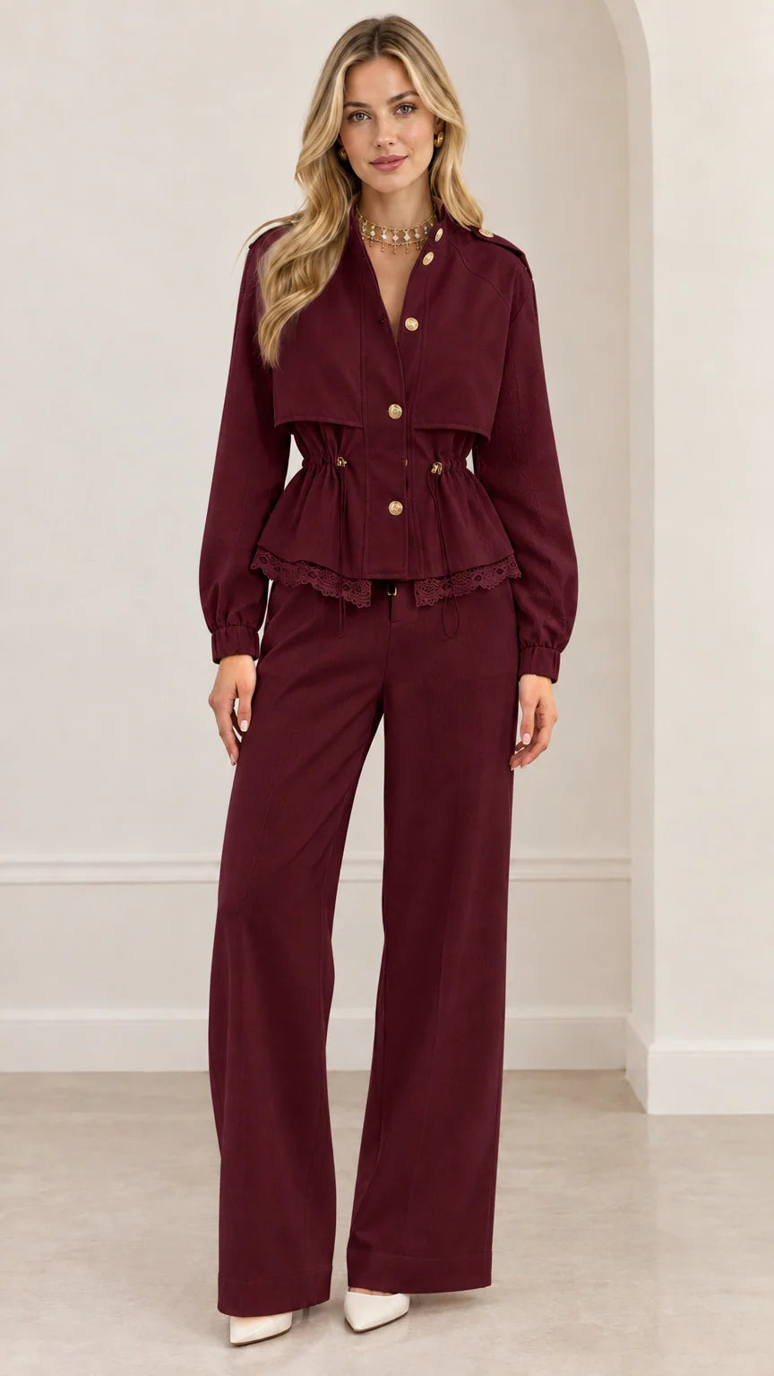 Full-length view of woman wearing burgundy wine red peplum jacket and matching wide-leg trousers