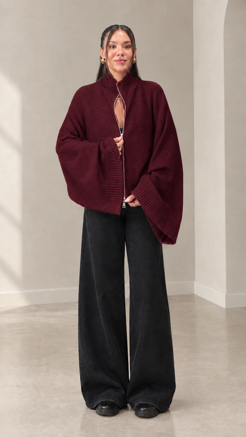 Woman wearing burgundy zip-front mock neck knit sweater