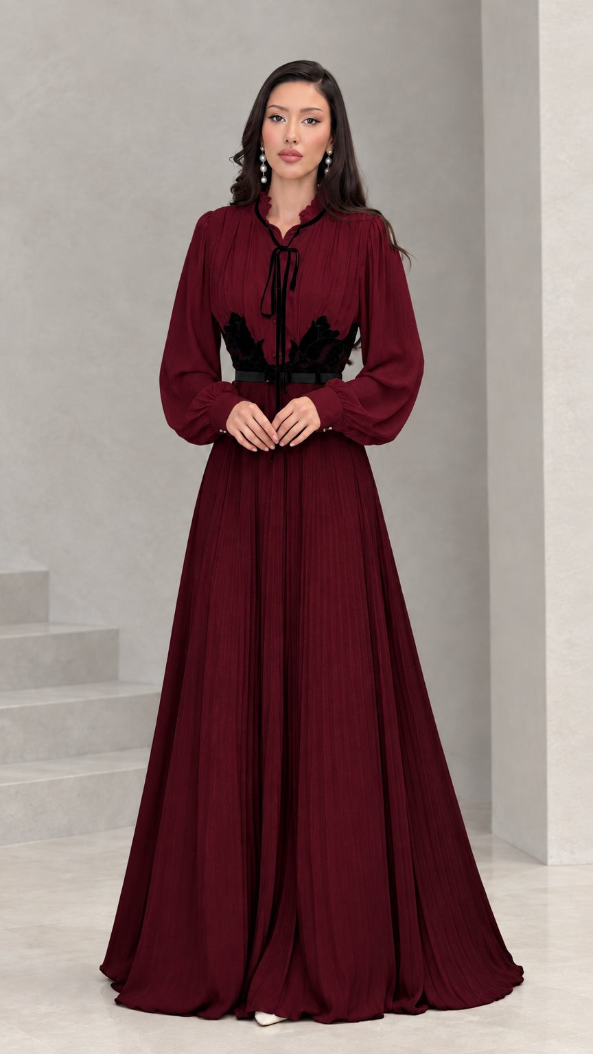 Full front view of burgundy and black long sleeve pleated maxi dress