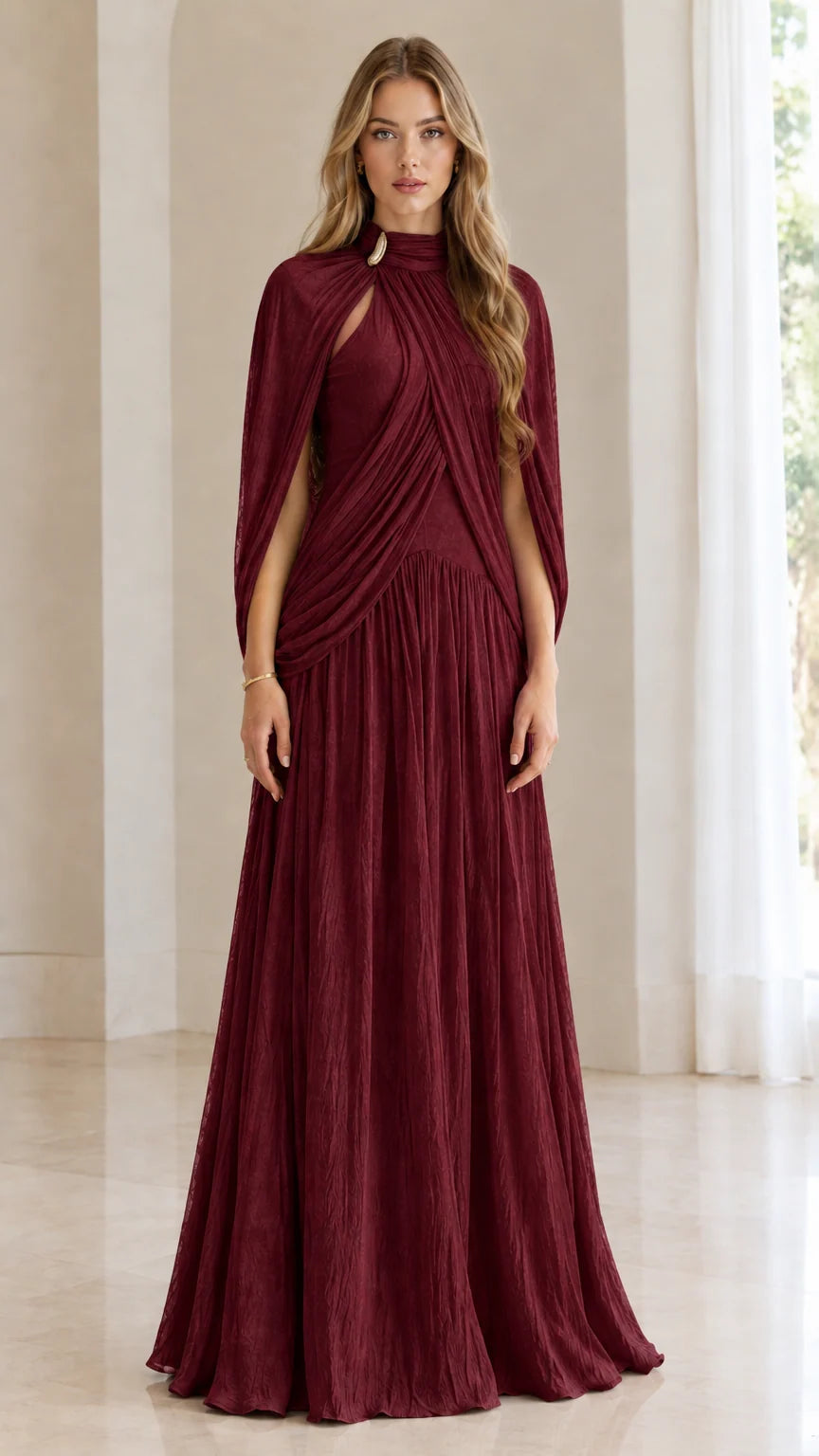 Front full-length view of woman wearing burgundy wine pleated cape-sleeve maxi dress
