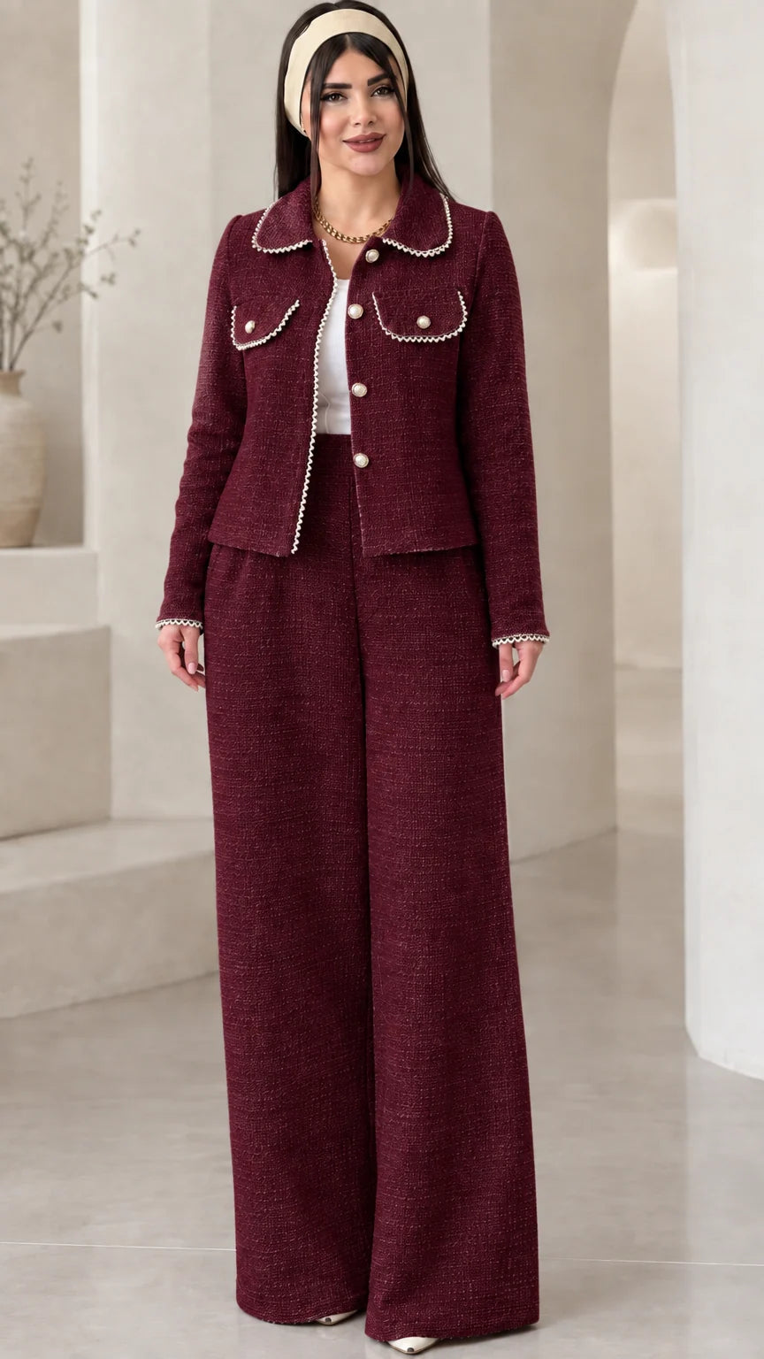 Front view of model wearing the burgundy red pearl-embellished tweed two-piece suit set