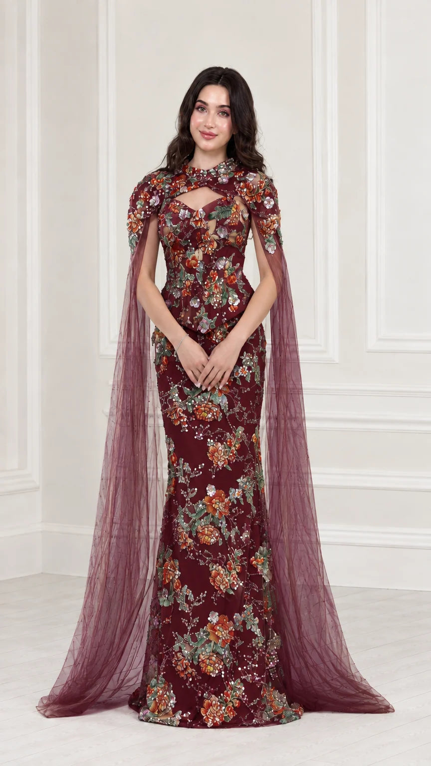 Front view of Burgundy floral embroidered evening gown with sheer wine red cape