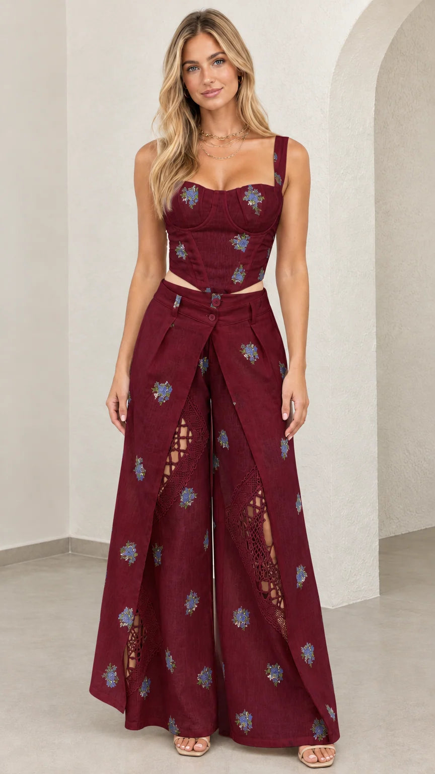 Model wearing burgundy floral embroidered bustier top and wide leg pants set