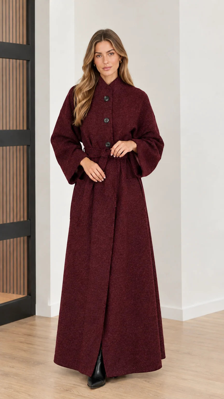 Front view of woman wearing deep burgundy red belted maxi overcoat