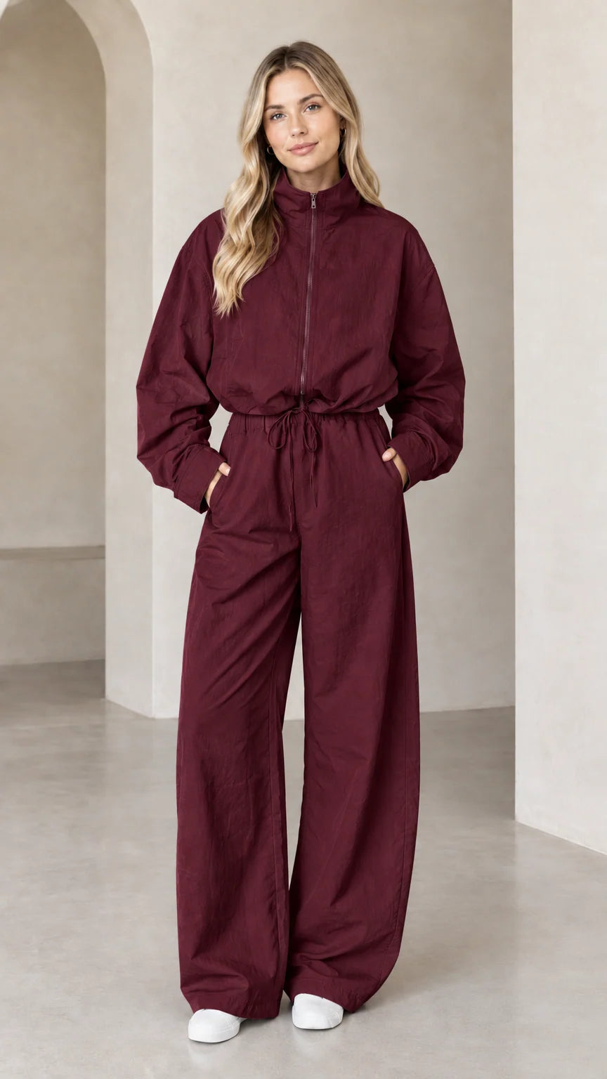 Front full-length view of woman wearing Burgundy zip-up wide-leg utility jumpsuit