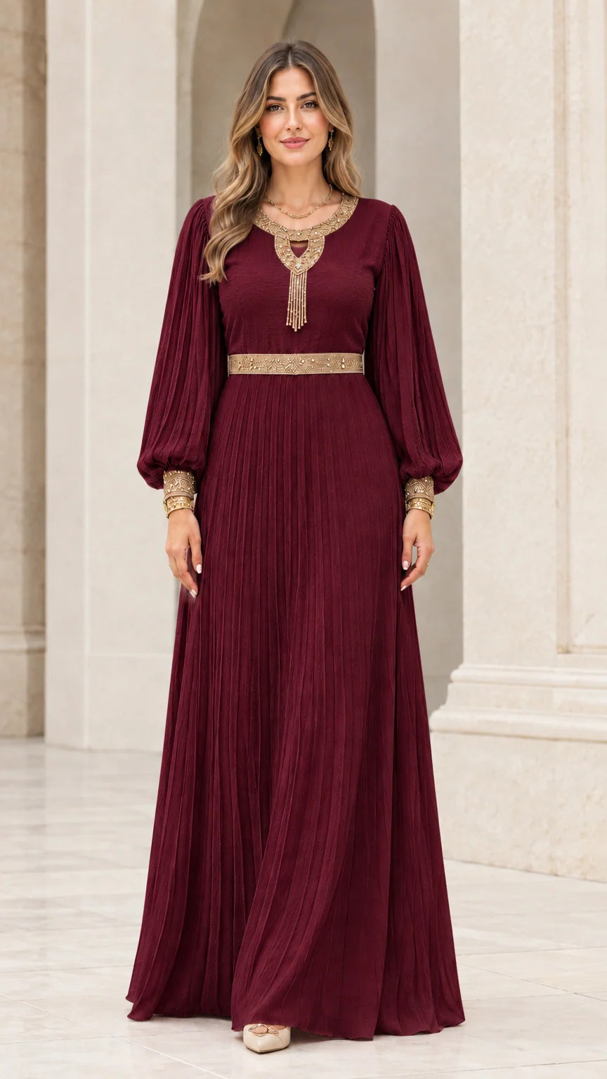 Front view of rich burgundy wine pleated maxi dress with gold embroidery