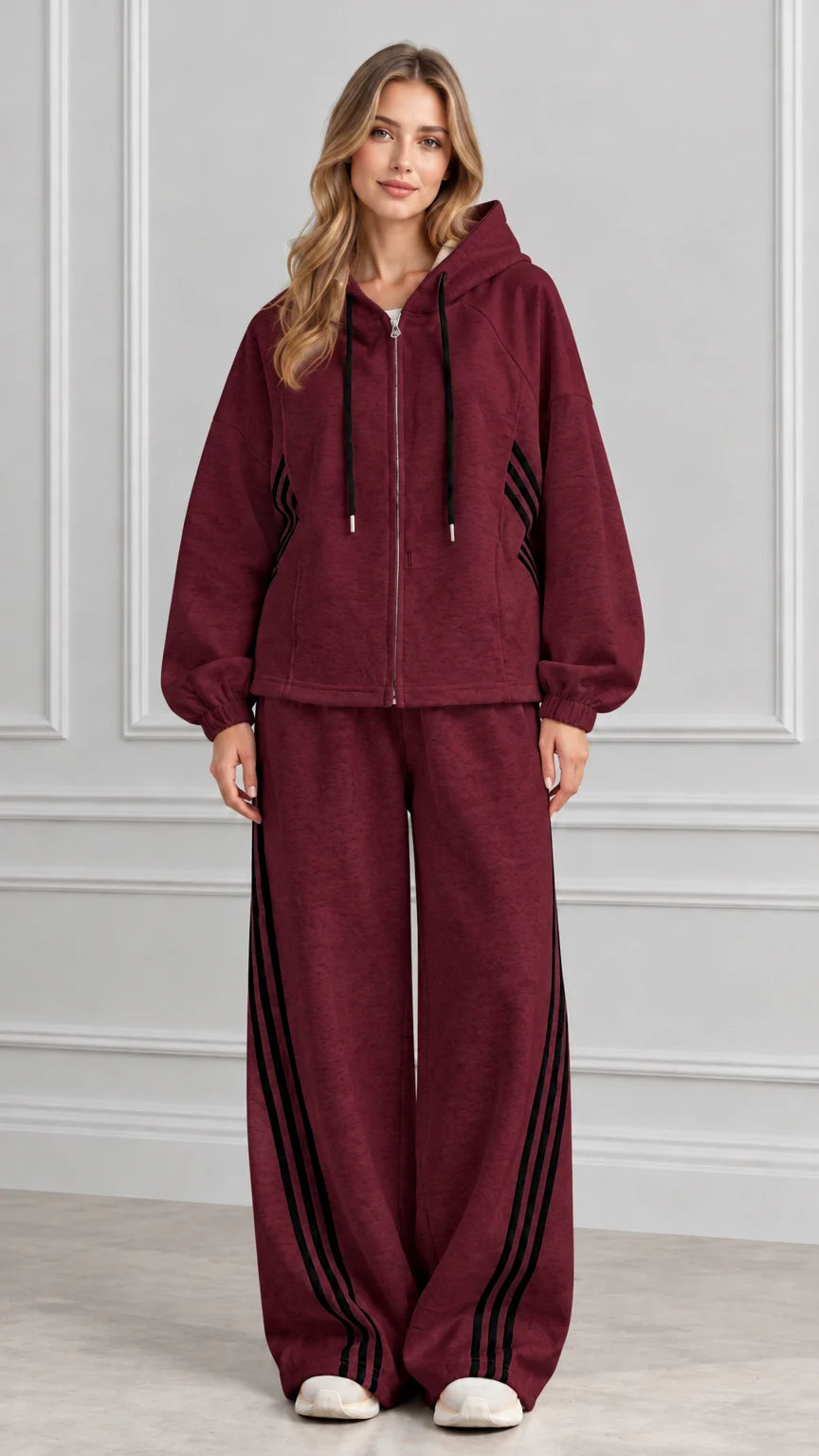 Front view of woman wearing Burgundy zip-up hoodie and wide-leg striped tracksuit set