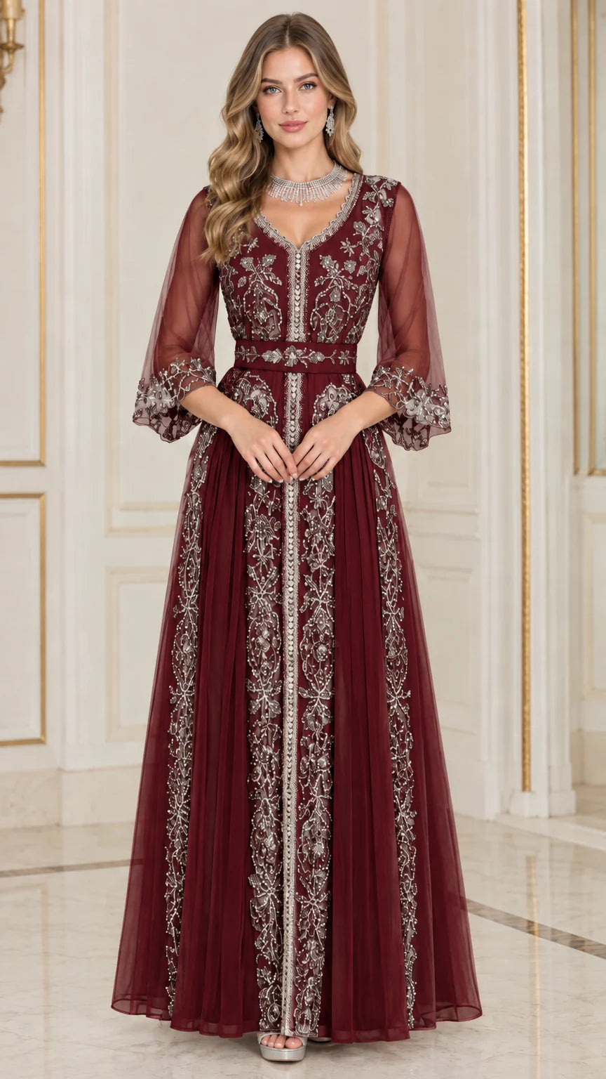 Front full-length view of woman in burgundy red embroidered beaded evening dress