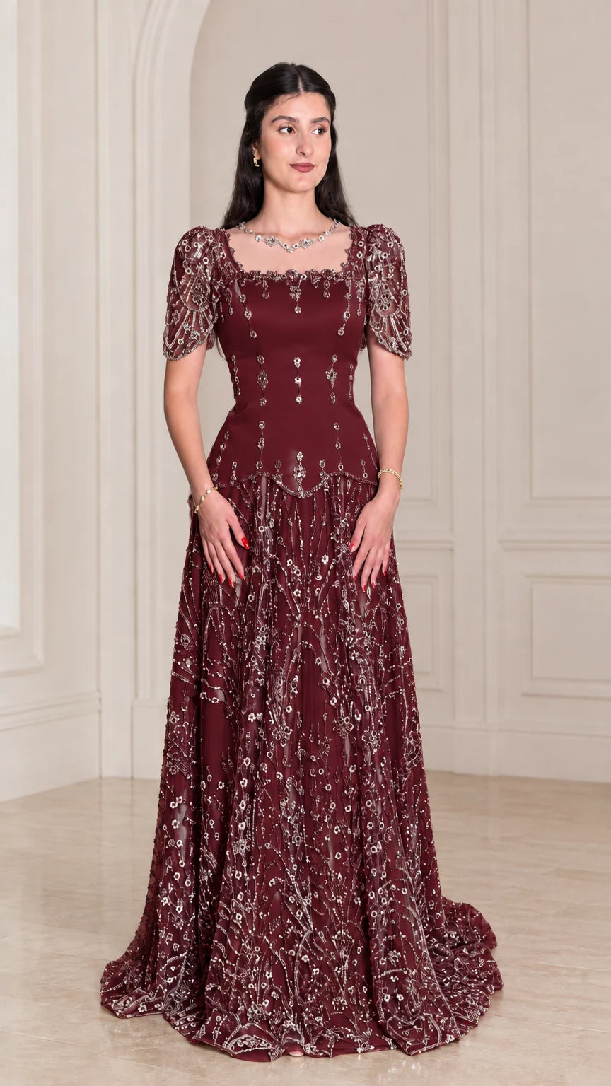 Model wearing rich Burgundy beaded floor-length gala dress