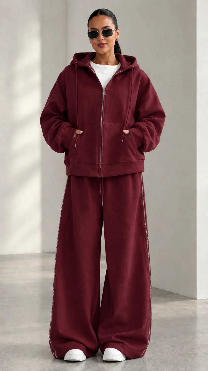 Model wearing Burgundy red zip-up hoodie and matching wide-leg track pants set