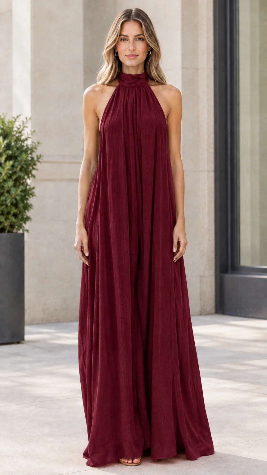Front view of model wearing deep burgundy halter neck wide-leg jumpsuit