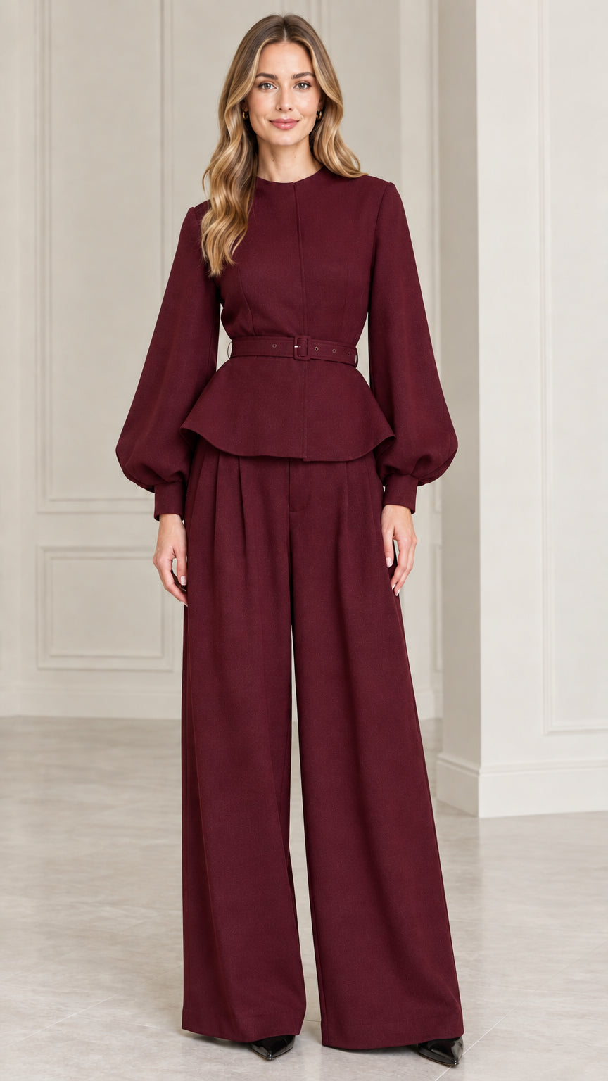 Full-length studio shot of model wearing Burgundy belted peplum top and wide-leg pants set