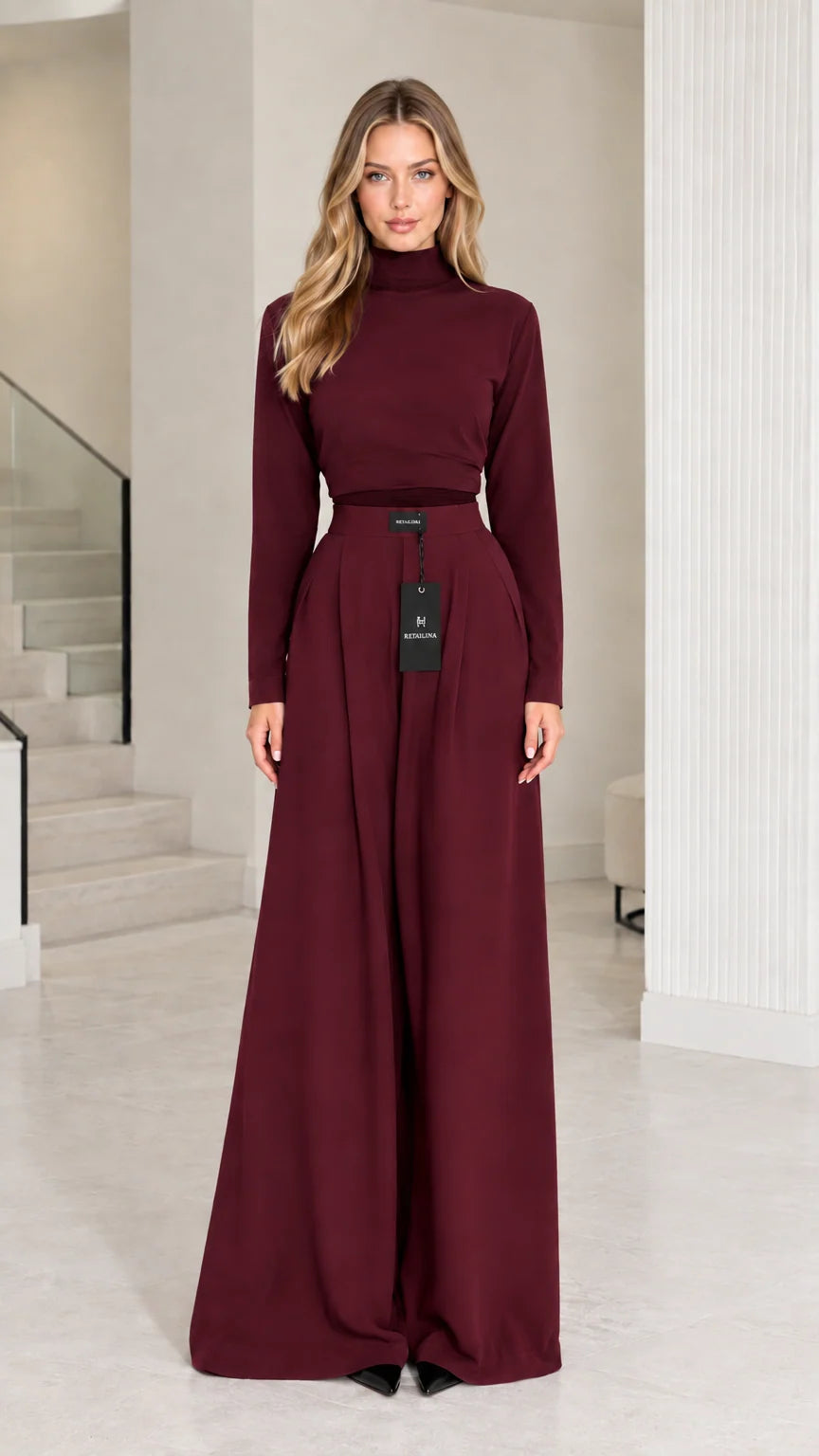 Front view of model wearing burgundy wine mock neck top and wide-leg trousers set