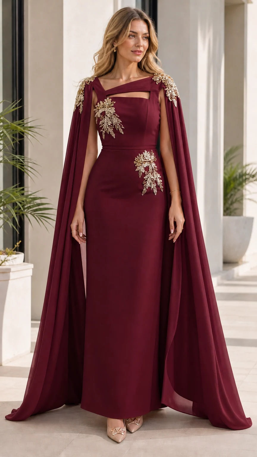 Woman wearing burgundy evening dress with attached cape