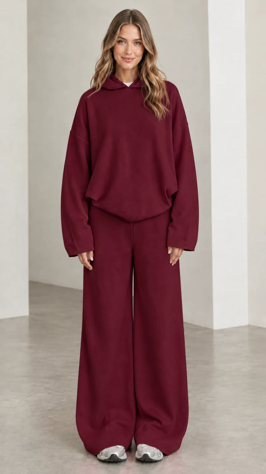 Front view of woman wearing Burgundy hooded sweatshirt and wide leg trousers matching set
