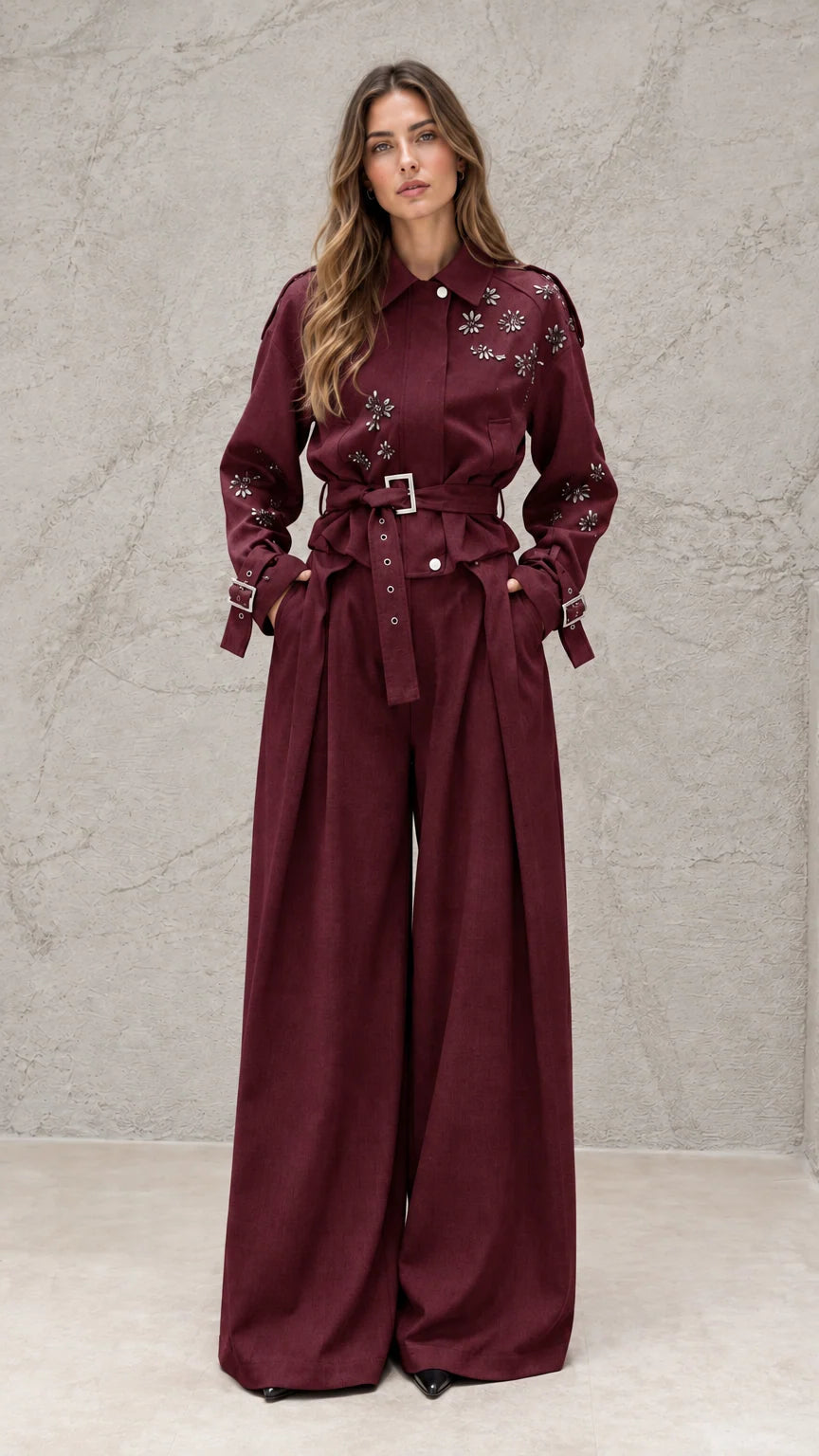 Full front view of model wearing burgundy embellished wide-leg jumpsuit