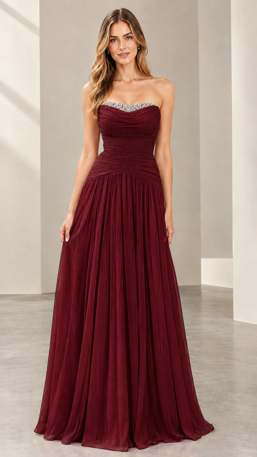 Front view of woman wearing the strapless ruched evening gown in burgundy wine