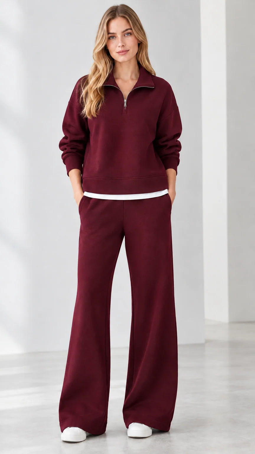 Front view of model wearing burgundy red quarter-zip sweatshirt and wide-leg sweatpants set