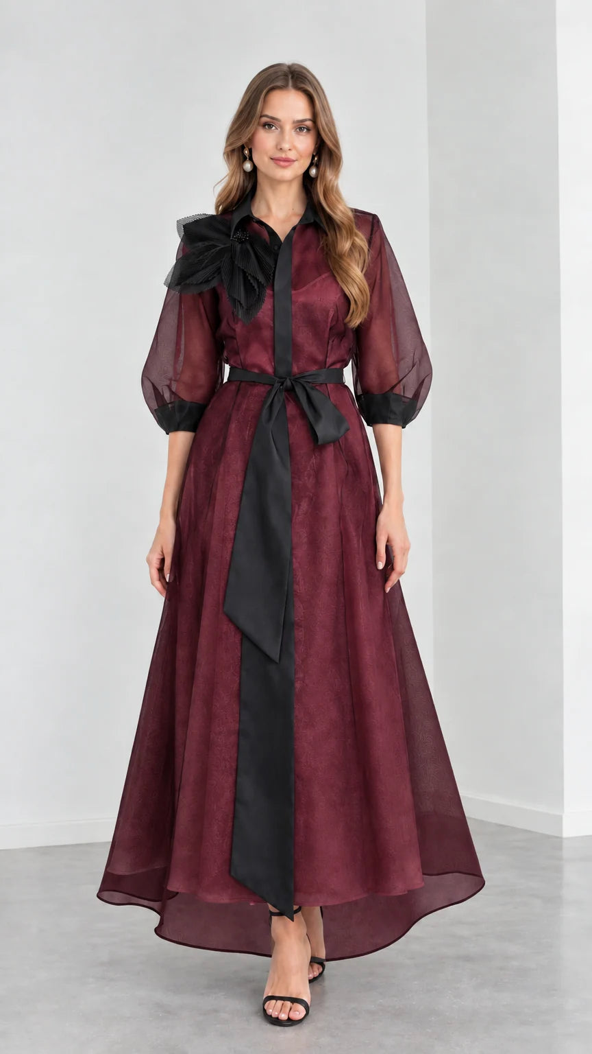 Front view of model wearing rich Burgundy wine organza maxi gown with black ribbon belt