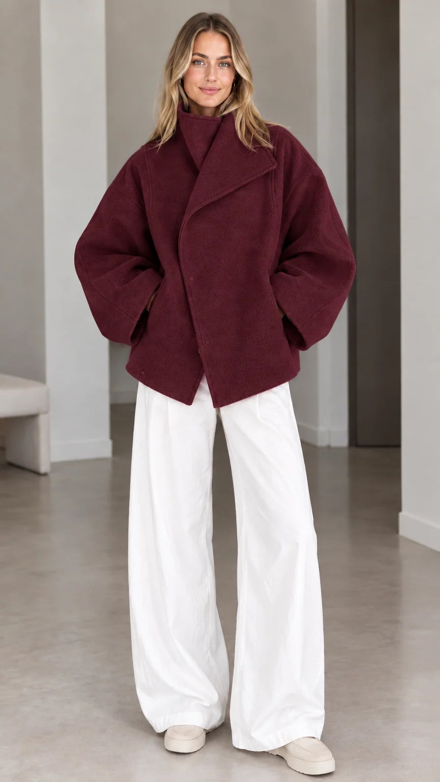 Model wearing deep burgundy wine asymmetrical snap-front short coat