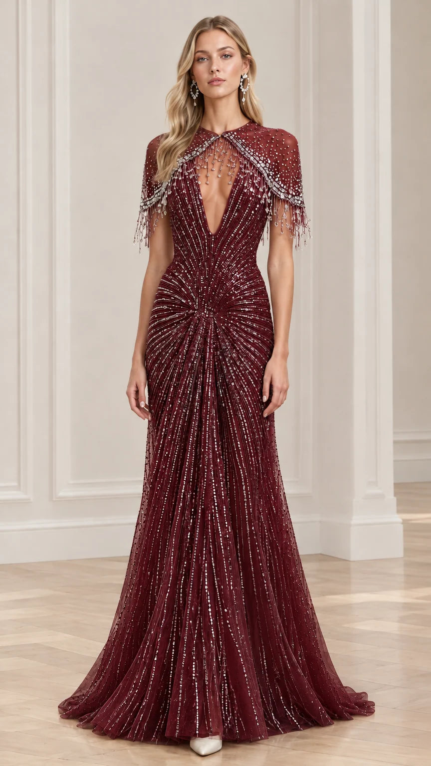 Front view of burgundy red embellished formal gown with plunge neck and cape sleeves