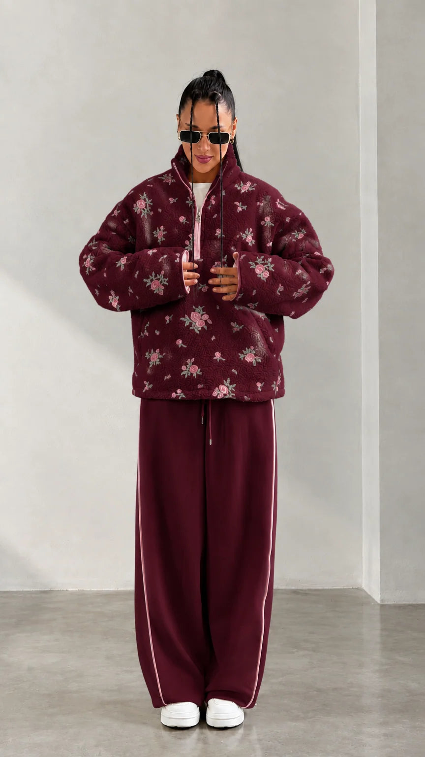 Front view of model wearing burgundy floral print half-zip fleece pullover