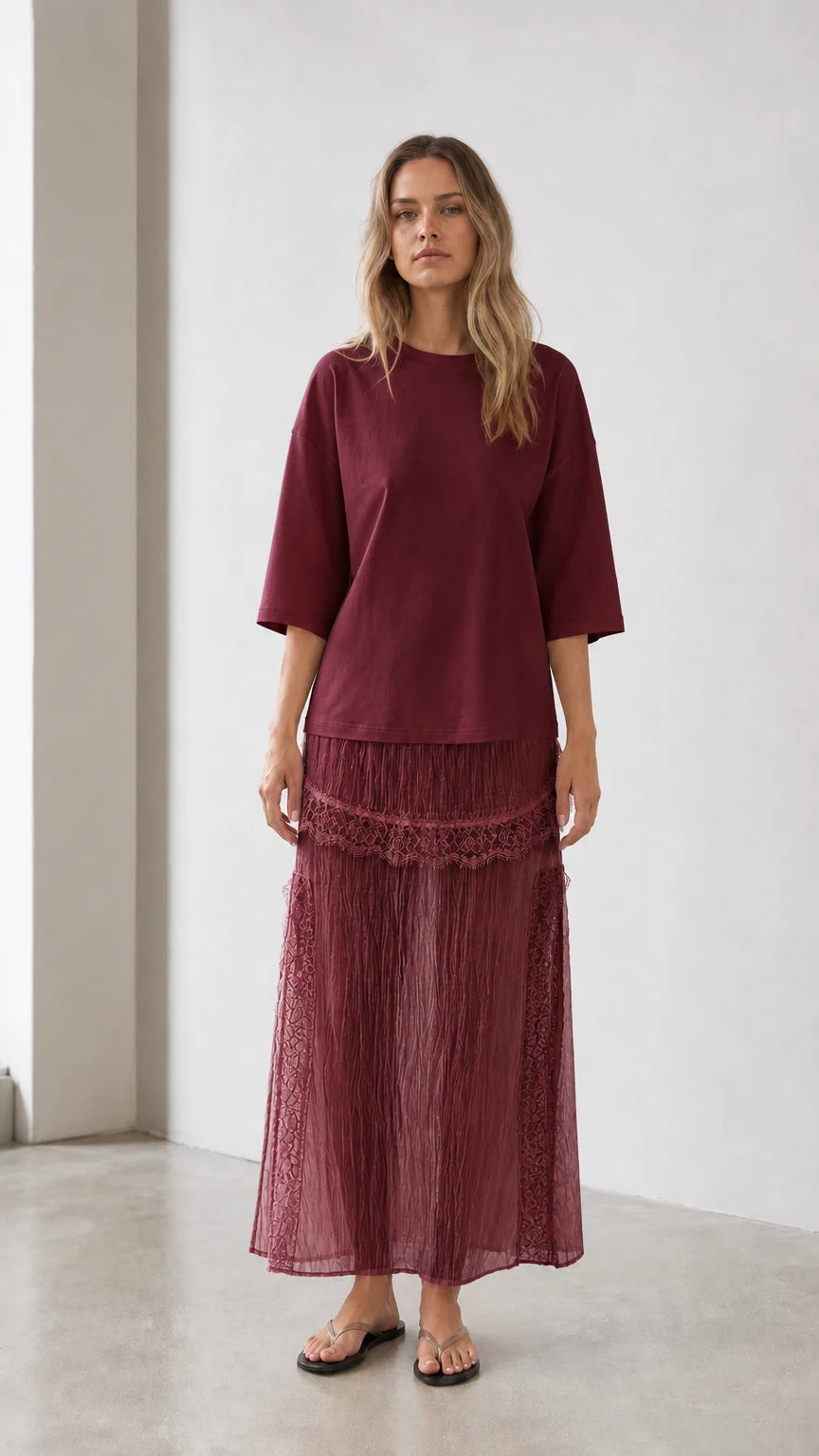 Front view of woman wearing burgundy relaxed tee and matching skirt set