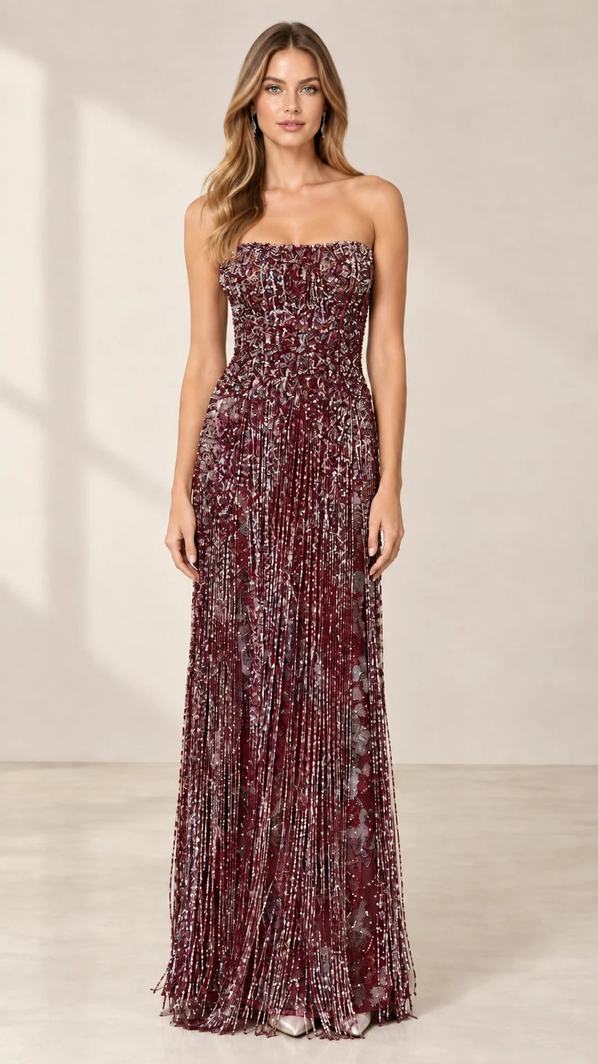 Front view of model wearing burgundy strapless beaded fringe evening gown
