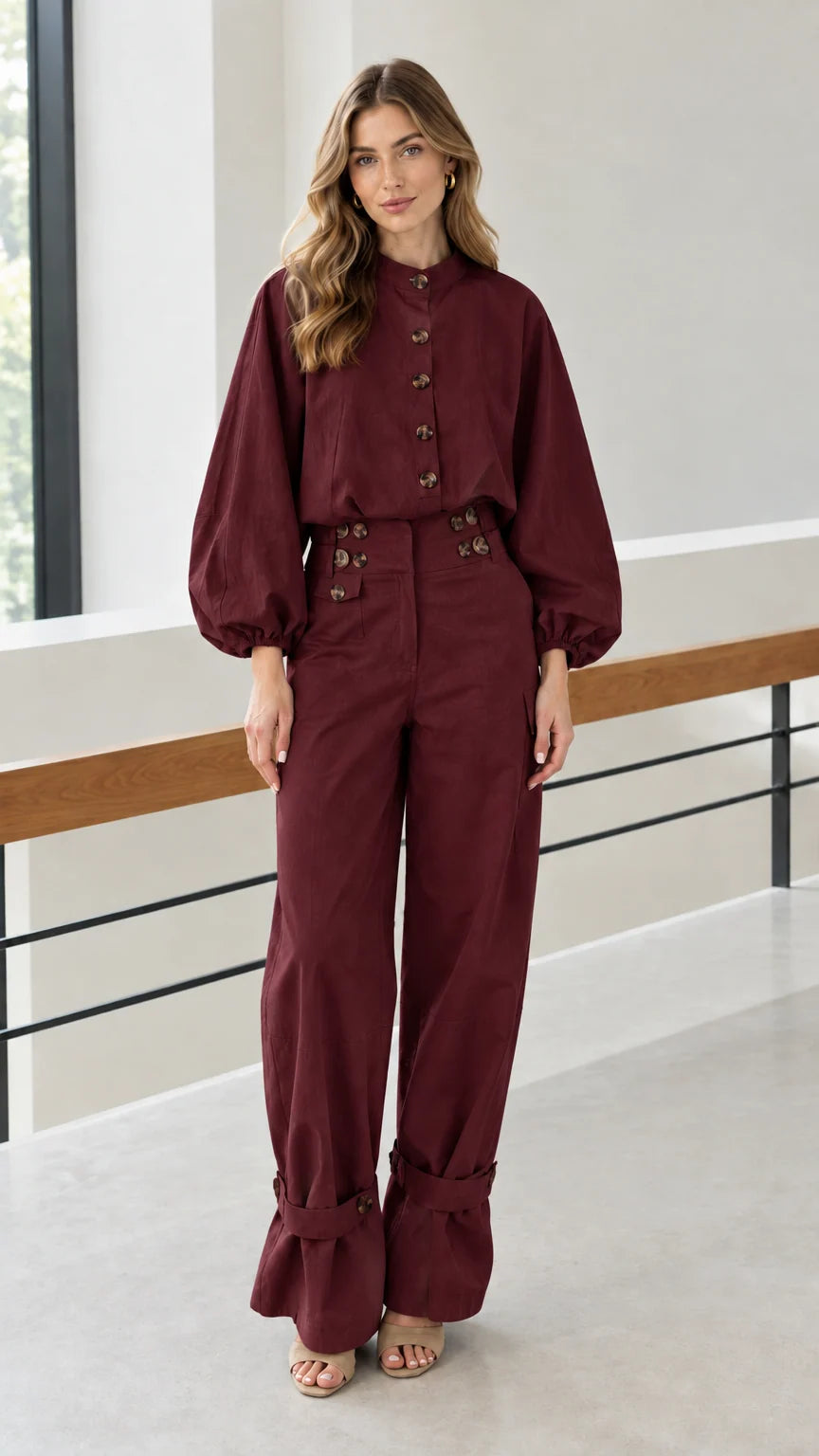 Front view of woman wearing burgundy two-piece utility blouse and pants set