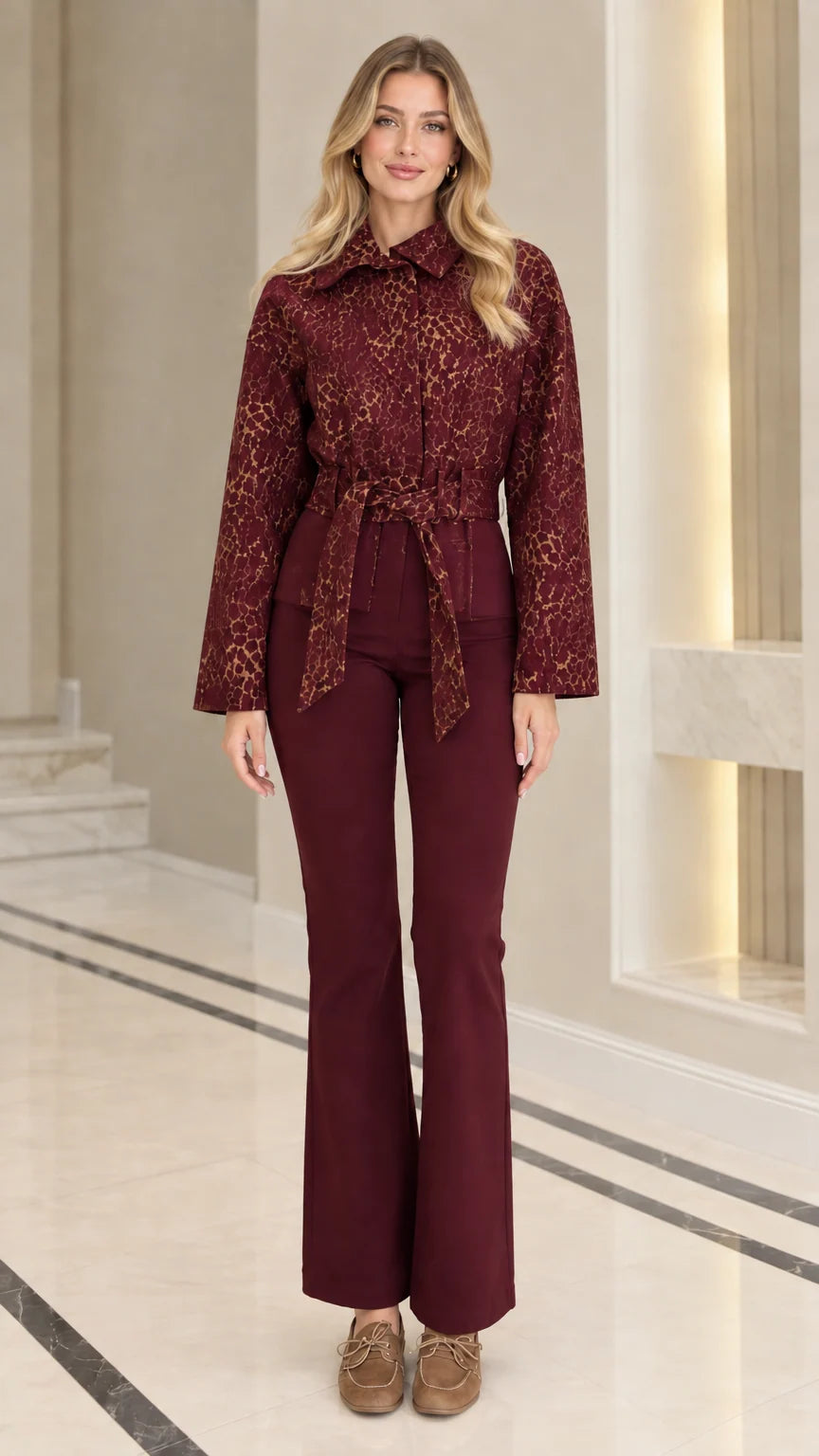 Front view of model wearing burgundy wine red textured jacquard belted jacket