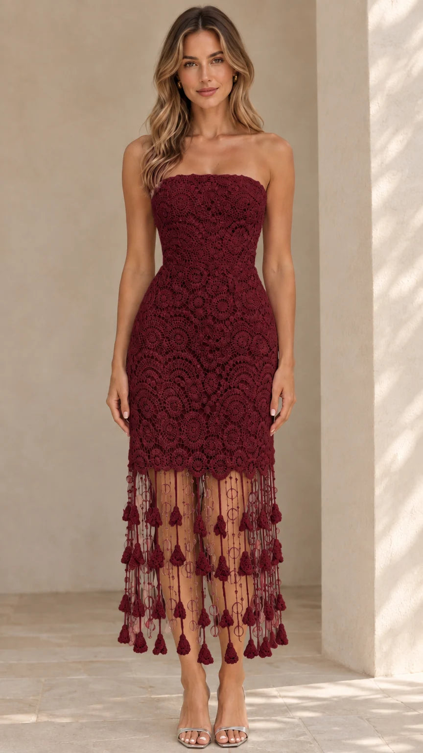 Front view of model wearing burgundy strapless lace midi dress with tassel hem