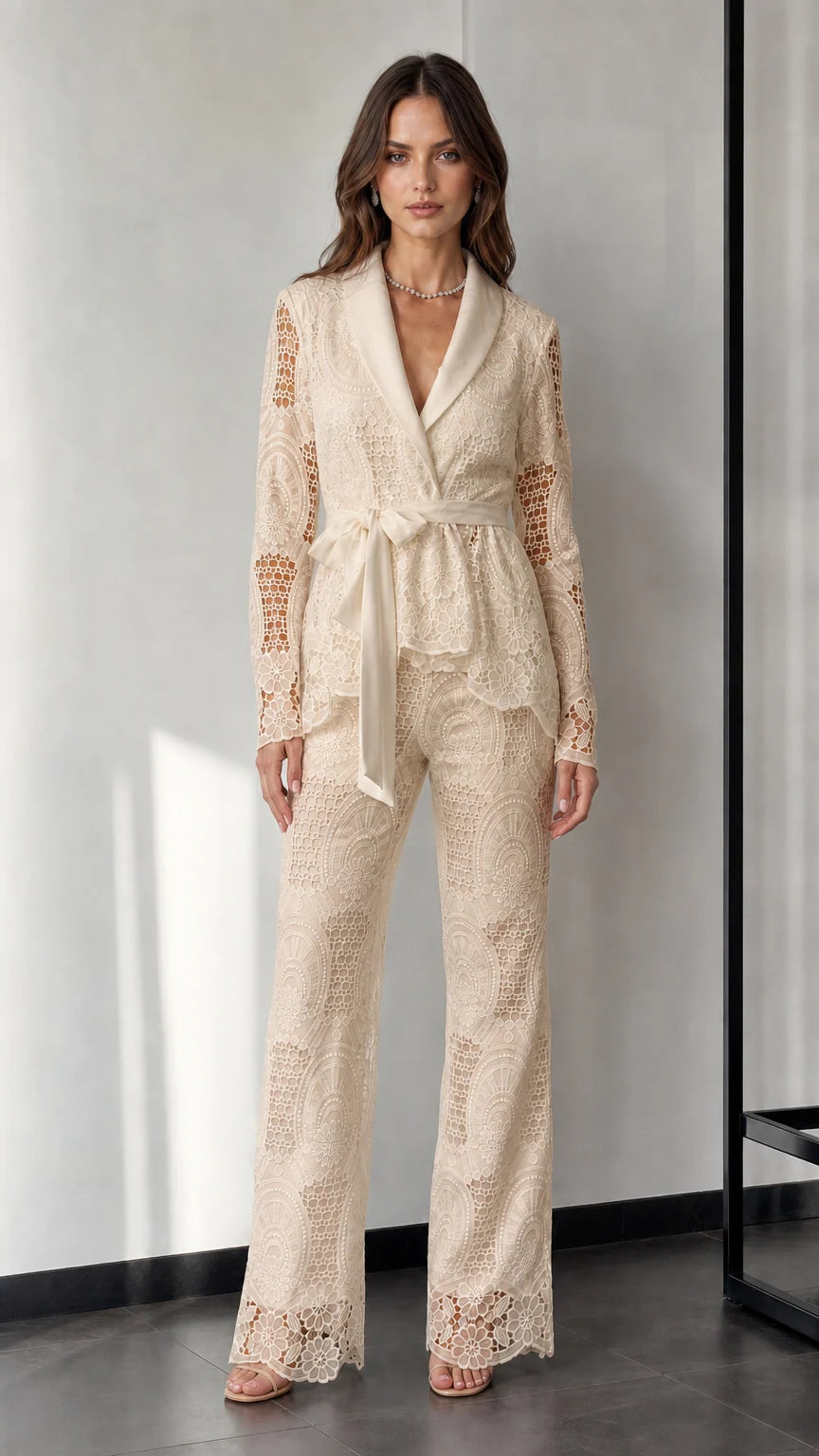 Woman wearing beige lace blazer and trousers set