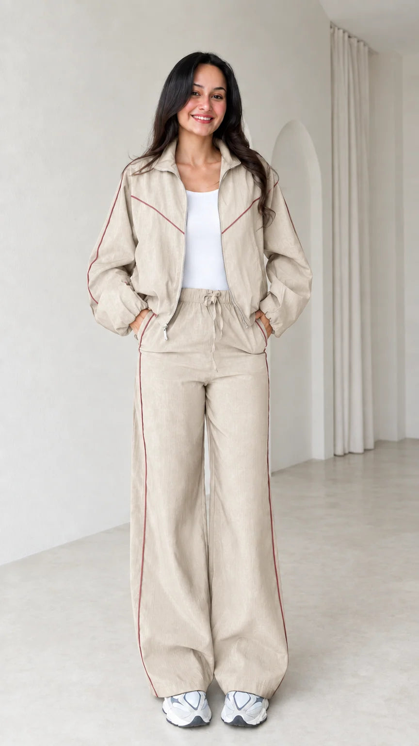 Model wearing beige zip track jacket and wide leg pants set