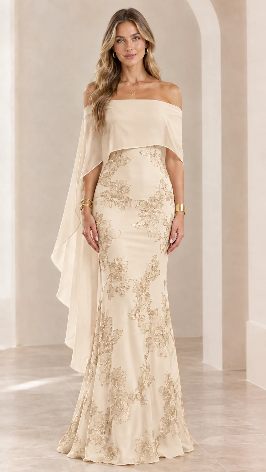 Woman wearing champagne off-the-shoulder embroidered cape evening gown