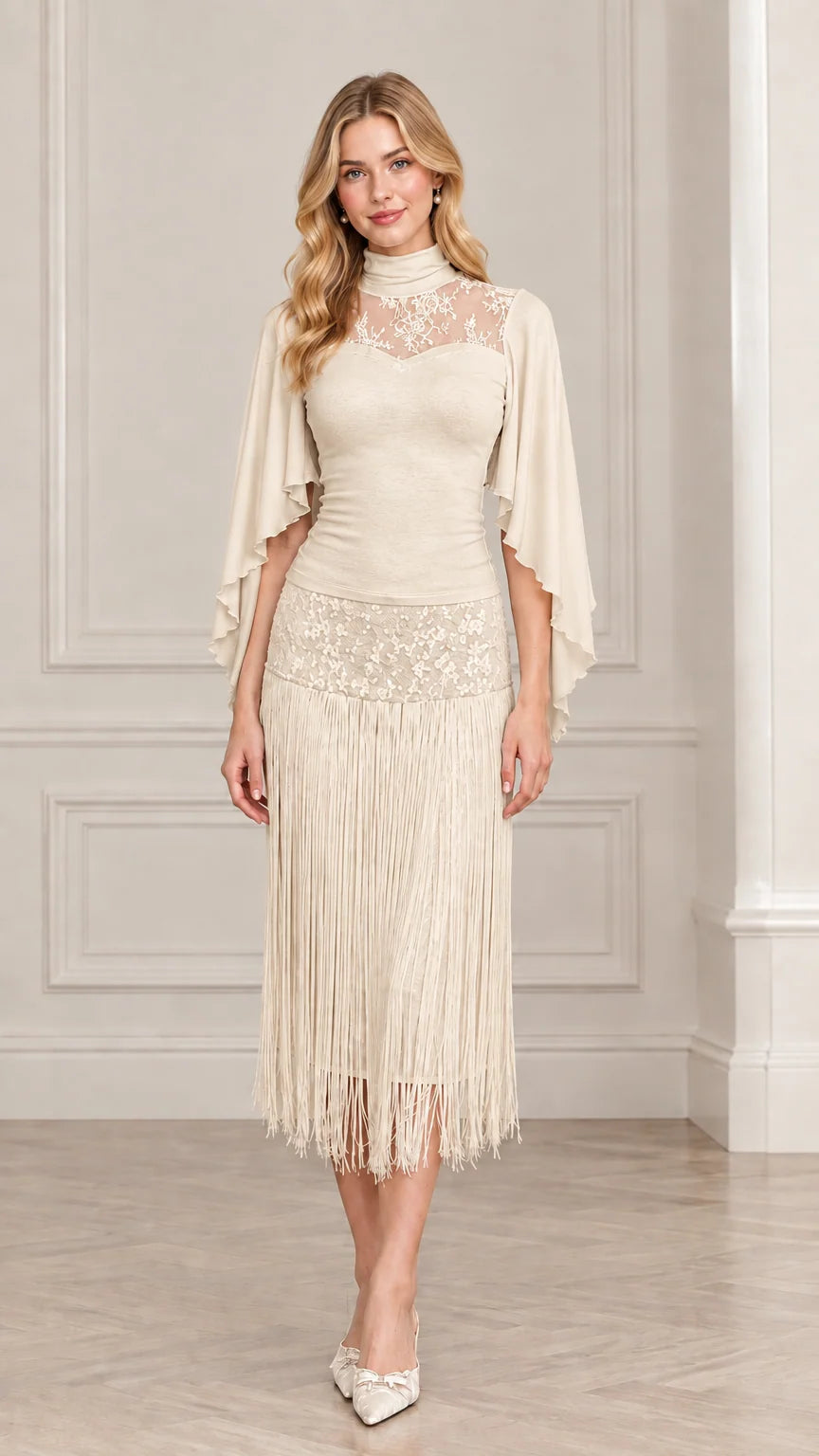 Front view of model wearing champagne cream lace cape sleeve fringe dress