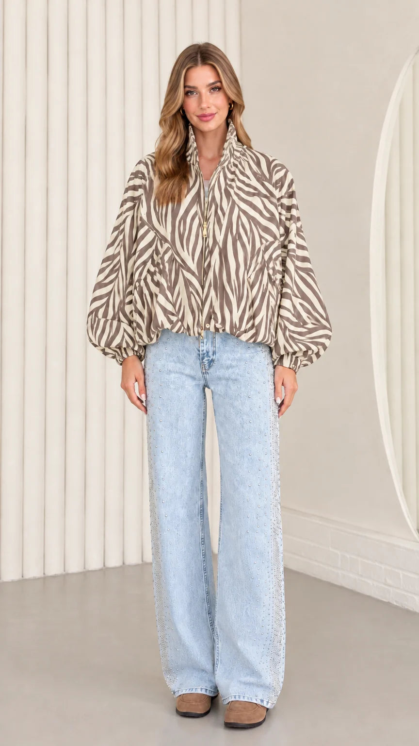 Model wearing taupe beige zebra print zip-up blouson jacket