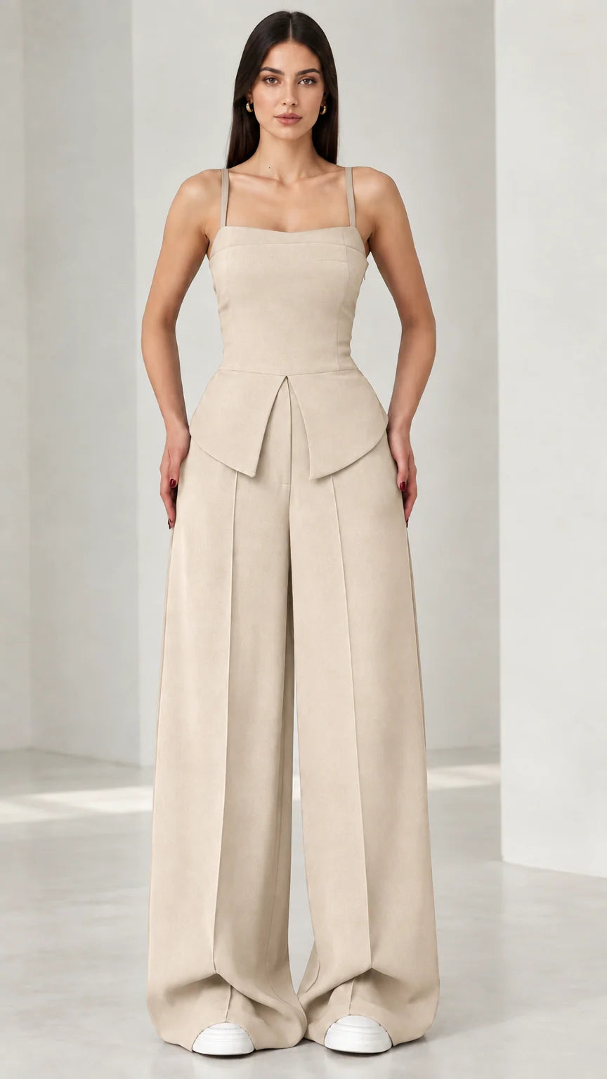 Full front view of model wearing beige square neck peplum wide leg jumpsuit