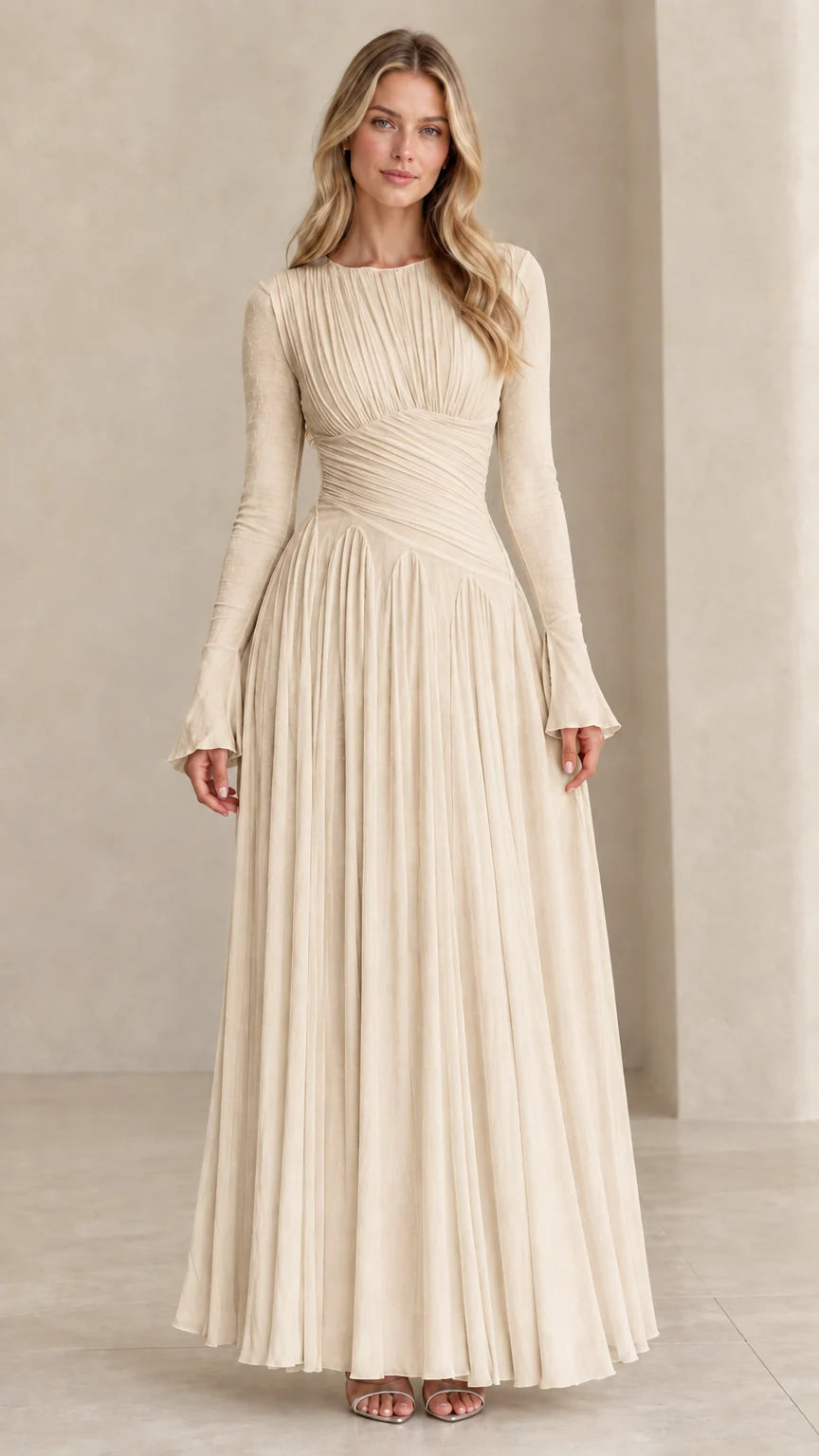 Model wearing champagne beige long sleeve pleated evening gown