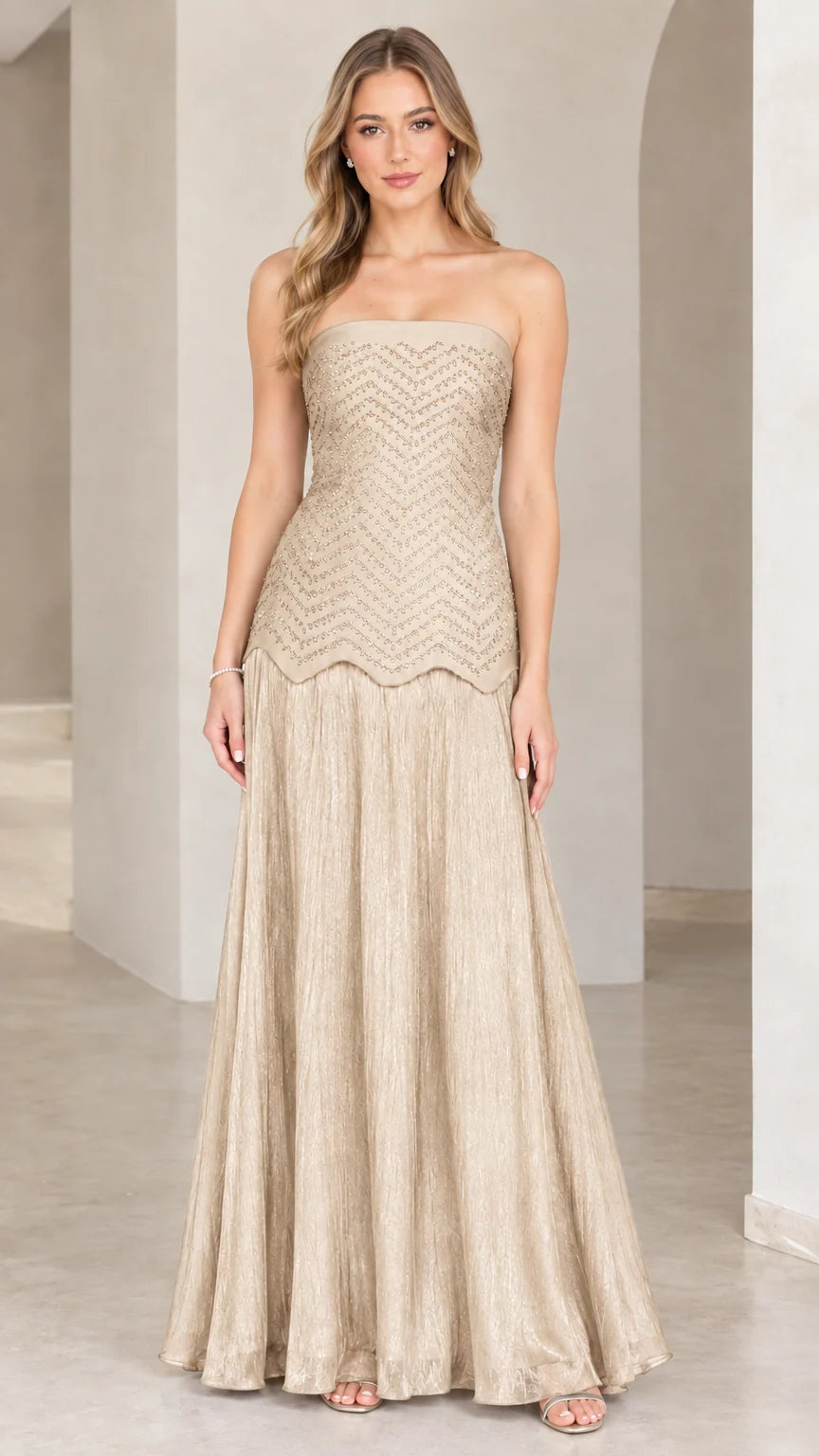 Full-length view of model in champagne gold strapless beaded evening gown