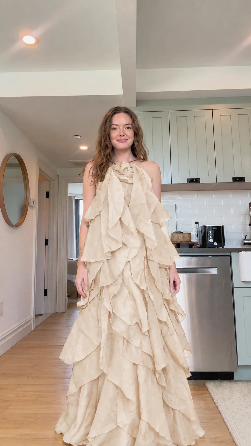 Front view of model wearing champagne beige tiered ruffle rosette maxi dress