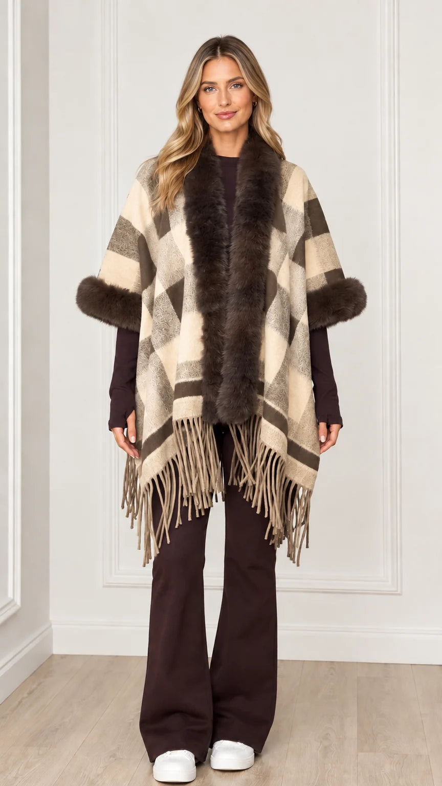 Woman wearing cream beige plaid poncho cape with faux fur accents
